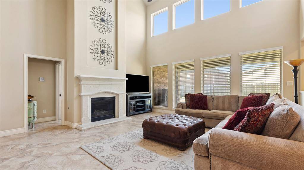 Beautiful family room towards the rear of the home with lots of light and warm and cozy fireplace