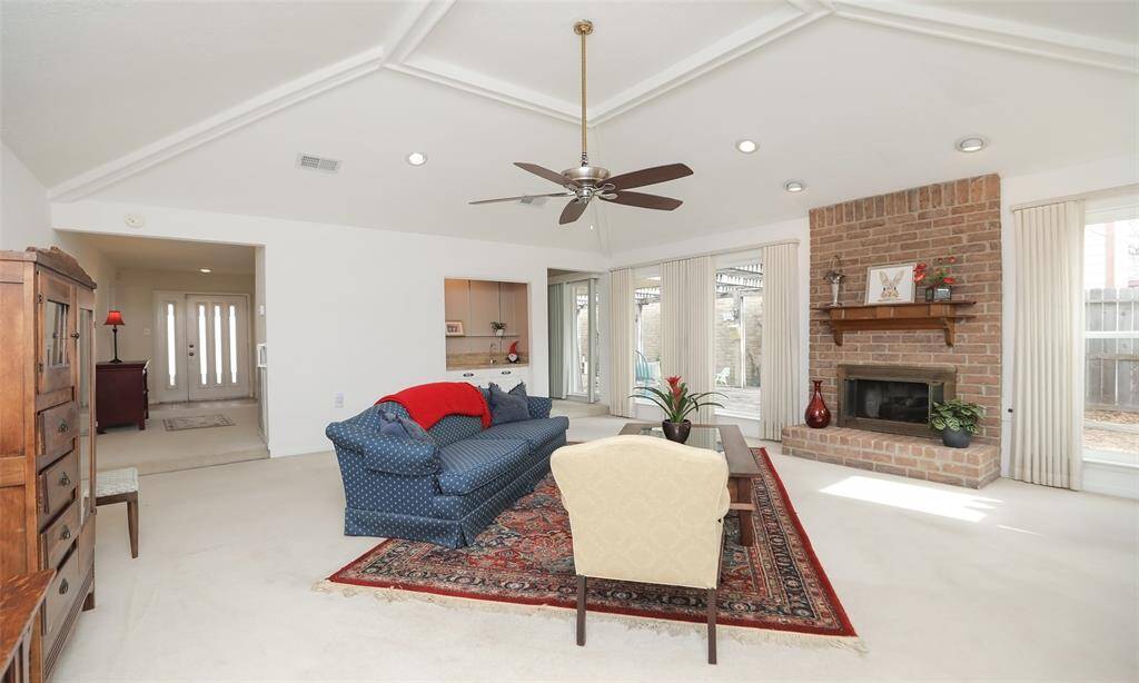 This large living room with beautiful fireplace is perfect for family and friends. Large windows around 2 sides of the living room allow for light and views of the deck.