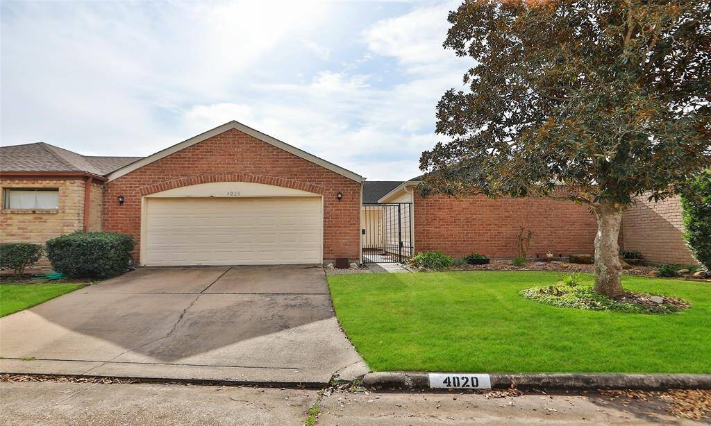 2 car garage and front gate leading to a private cortyard.