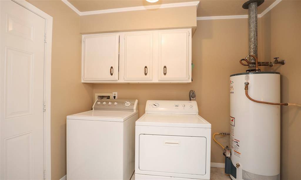 Hot water heater is located conveniently in the Laundry room which is right off the kitchen and leads to the attached garage.