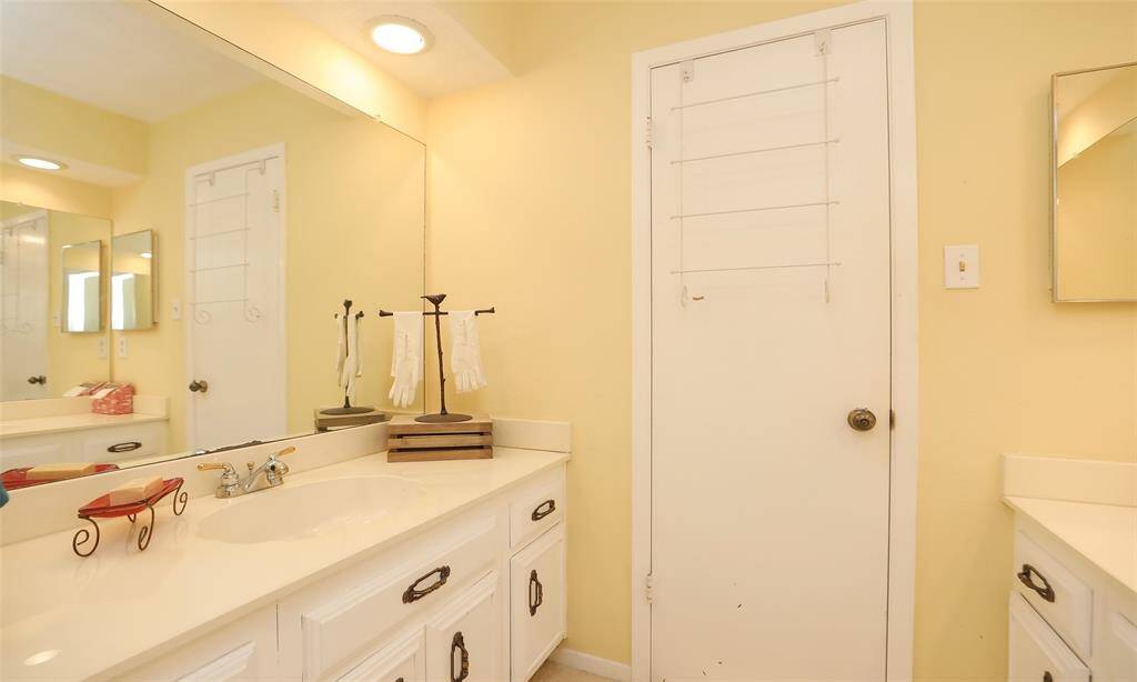 The secondary bathroom has cual vanities with separate mirrors and cabinets