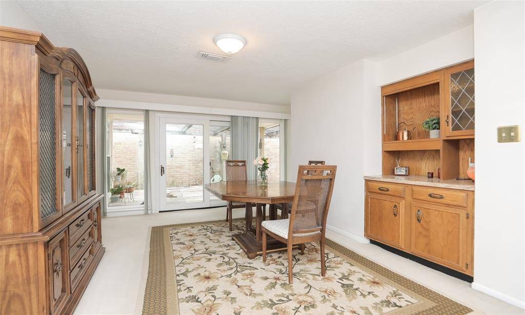Large dining room ready for intertaing and has sliding door that leads out to deck.