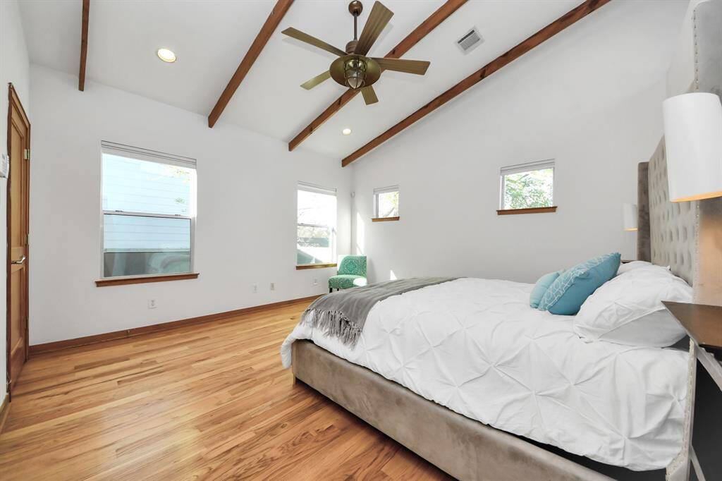 view of primary bedroom from the en-suite bathroom and walk-in closet with built-ins