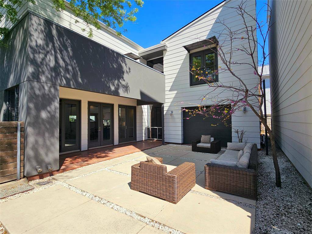 450 Oxford! Enjoy the private courtyard during the day or under the stars watching a movie on the included retractable screen! The additional garage door provides direct access to the garage when working outside from the courtyard area or if you need additional space for entertaining.