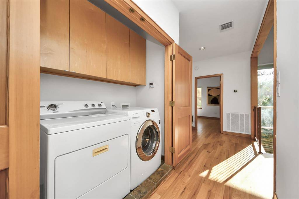 Laundry area with included washer and dryer is centrally located between upstairs bedrooms.