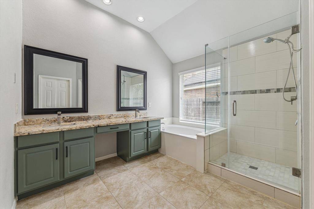 The Primary Bath features his/her vanities, a stand up shower & a soaking tub.