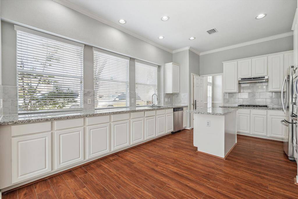 The Kitchen features tons fo counterspace and three large windows that fill the room with sunlight.