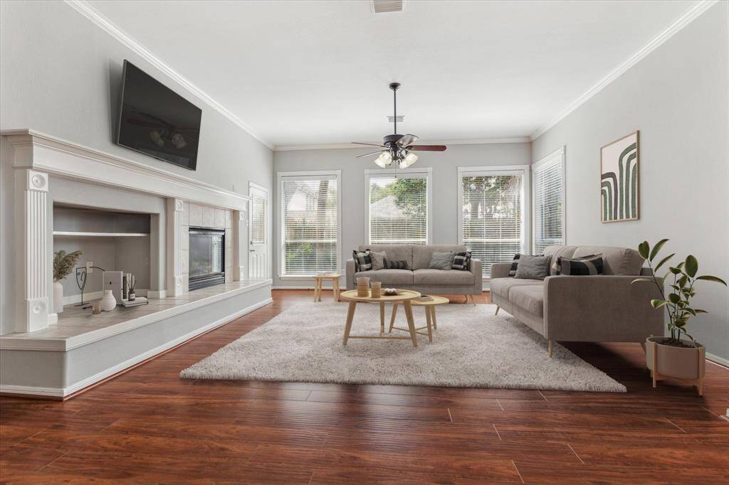 Enter into your spacious Living Room located off the Kitchen that features tons of natural light through a wall of windows and offers plenty of space for different furniture configurations. Virtually staged.