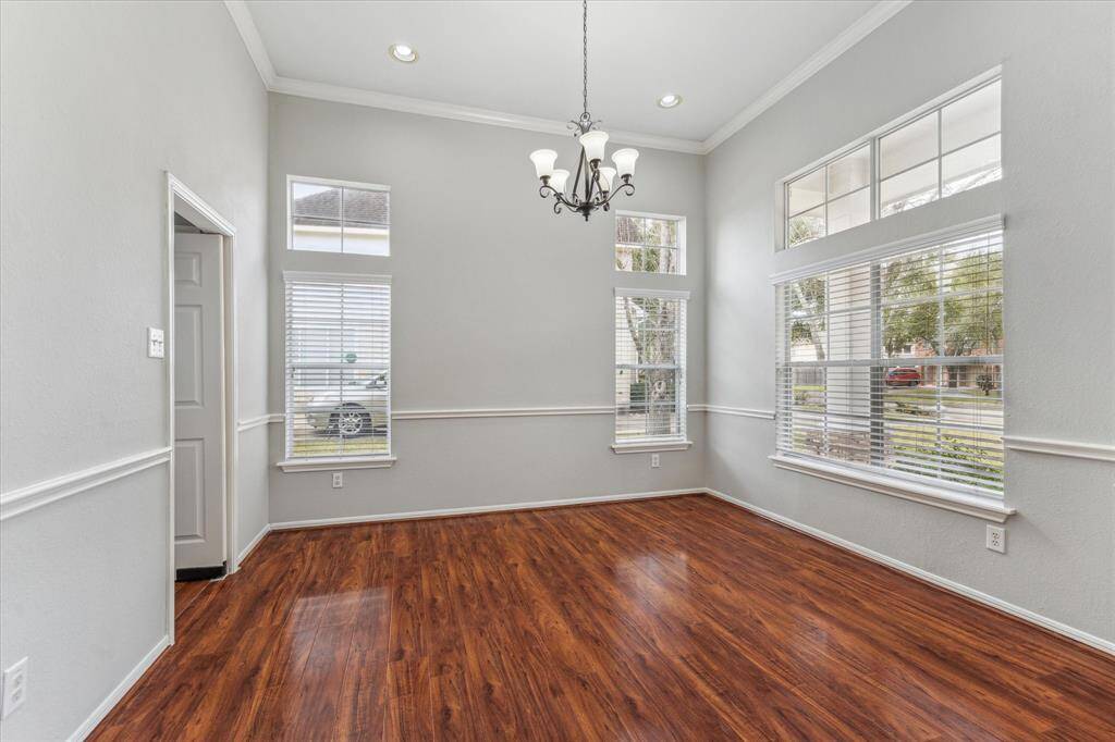 The Dining Room located at the front of the home features high ceilings & large windows.