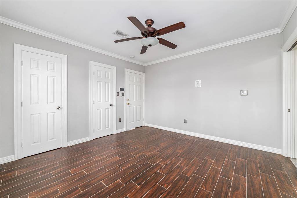 The primary bedroom with double walk-in closet and ceiling fan.