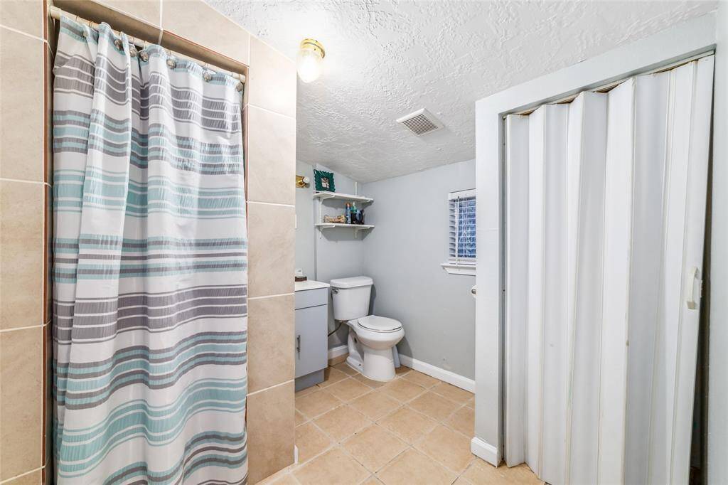 Full bathroom with toilet & shower.