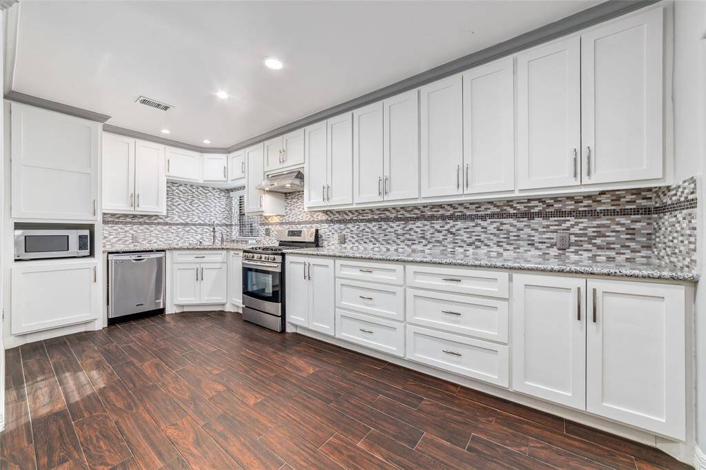 Premium looking kitchen with ton of storage and modernized ceiling-light features.
