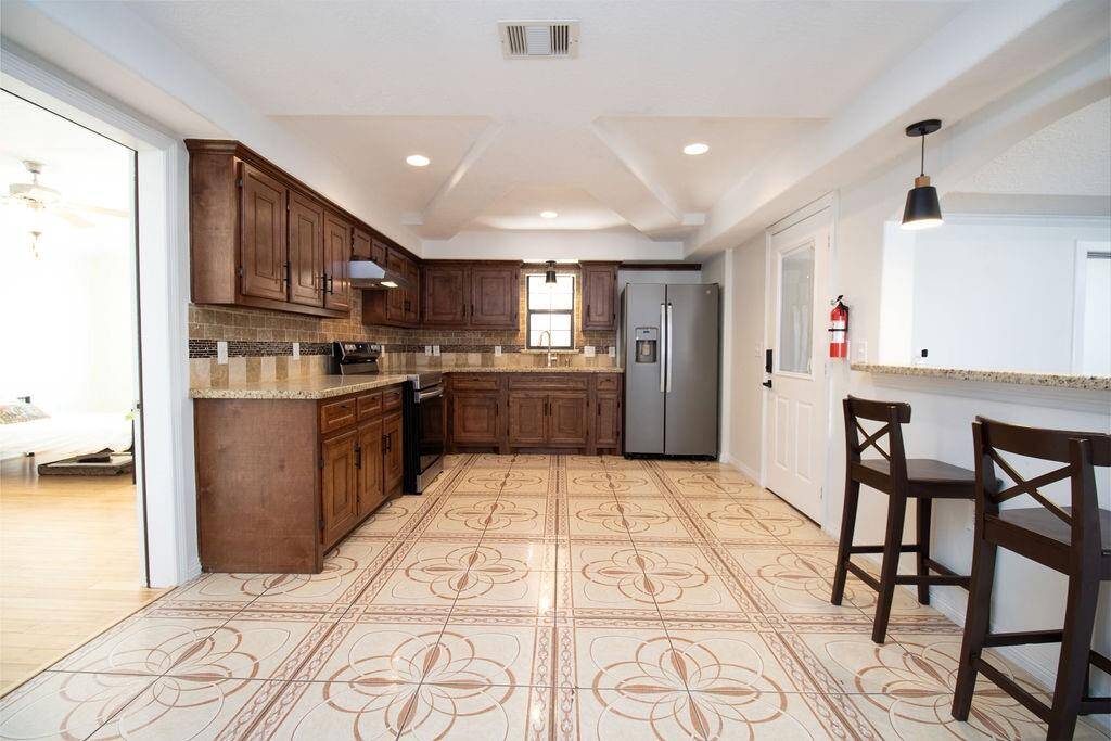 Large open concept Kitchen, with bar overlooking dinning room and living room and still plenty of room left.