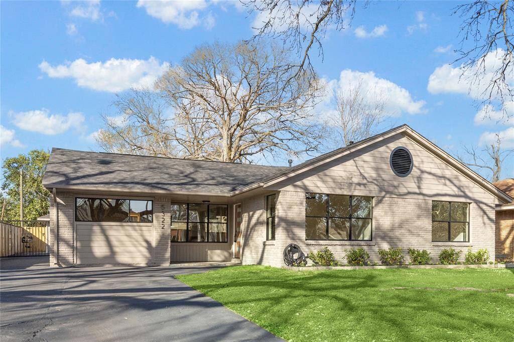 Welcome to your newly remodeled single-story home with a light gray brick exterior and a well-maintained lawn. It features large windows for ample natural light and a driveway leading to an over-sized 2 car detached garage. The property is surrounded by mature trees, providing a serene setting.