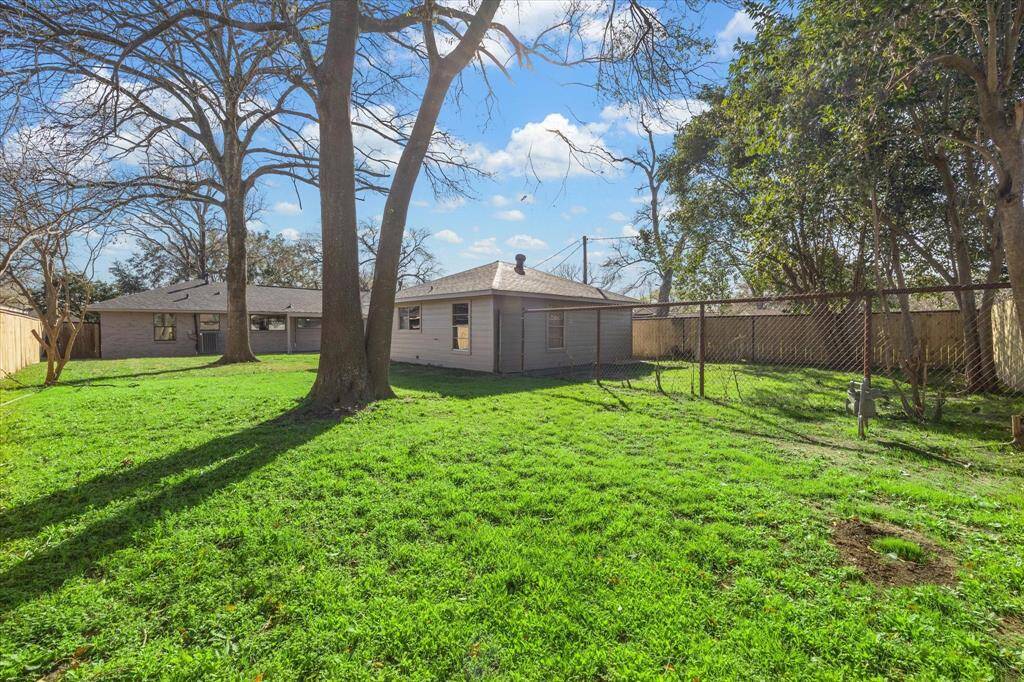 Spacious backyard   to accommodate a  swimming pool and still have plenty of yard space for the kids and puppies to run around. Also, tremendous amount of lush green grass, mature trees, and a fenced perimeter, offering privacy and a serene outdoor setting. Ideal for families and outdoor activities.