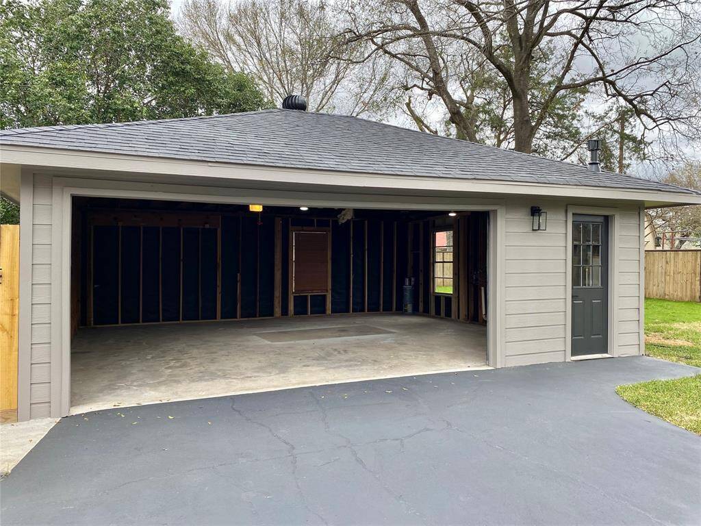 Spacious two-car garage offers ample parking front and back, with a newer roof from 2018.