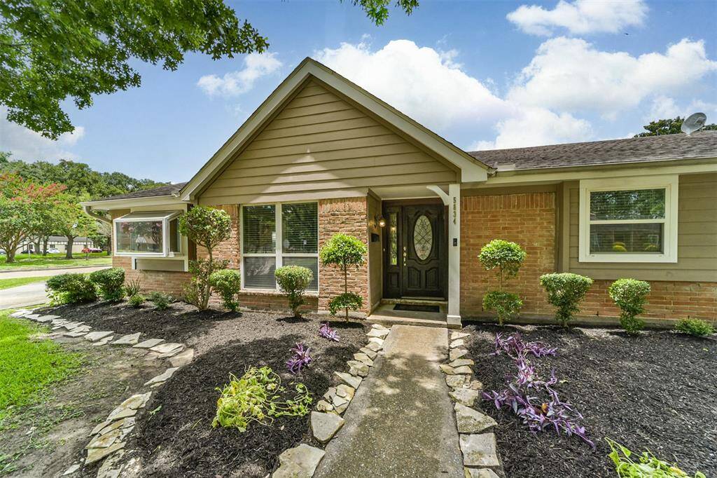 This charming single-story home features a welcoming brick exterior with a well-maintained front yard. It has a paved walkway, mature trees providing shade, and attractive landscaping with shrubs and flower beds. Ideal for buyers seeking a cozy, inviting atmosphere.
