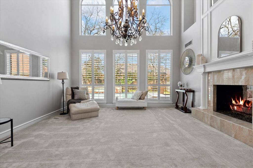 Plantation shutters and a sophisticated chandelier add a touch of class to the room.