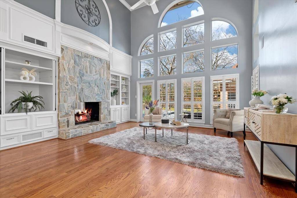 gorgeous blue stone fireplace with built-in cabinets and shelves provide extra storage in the family room.