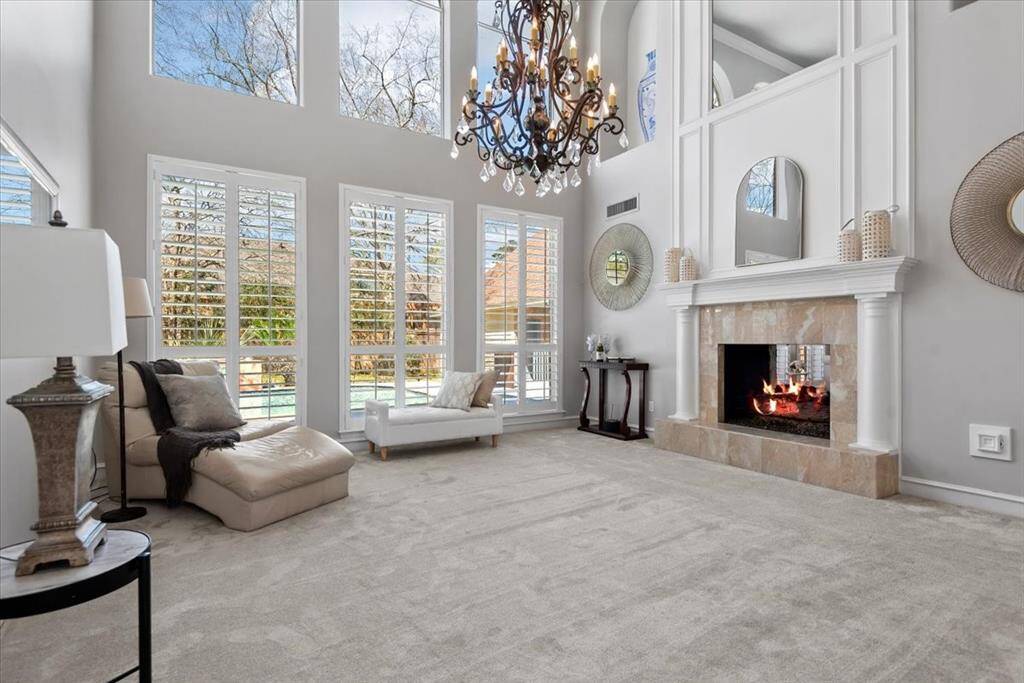 Abundant natural light streams in from tall windows in the living room.