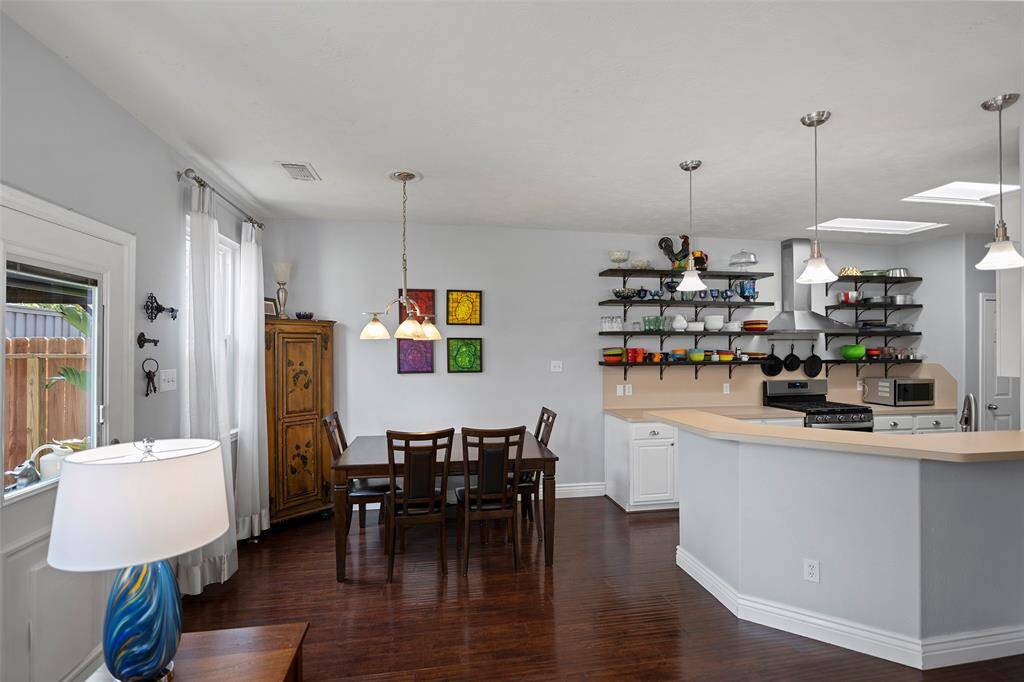 Bright, open kitchen and dining area with modern lighting.