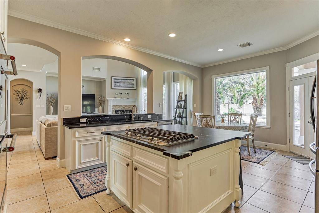 Enjoy stunning backyard views from the kitchen, enhanced by ample recessed lighting.