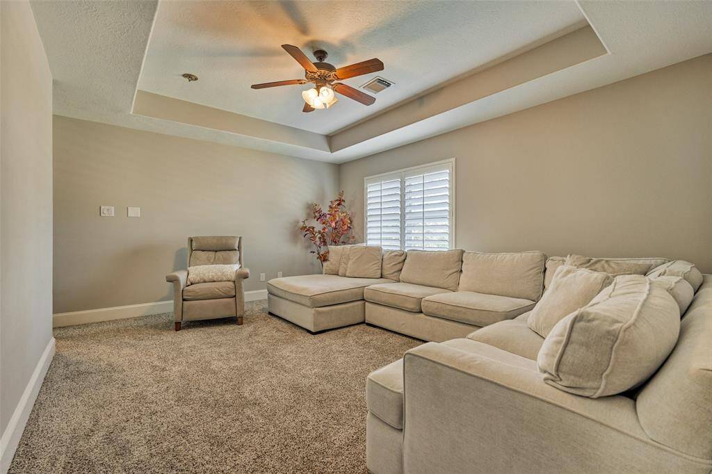 Versatile flex room perfect for a playroom, TV area, or cozy lounge.