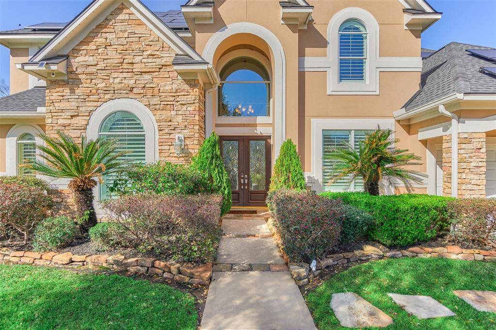 Elegant double-pane arch windows and a grand double-door entry enhance the stunning landscape views.