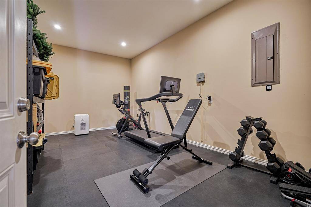 Spacious home gym with padded flooring for a comfortable workout experience.