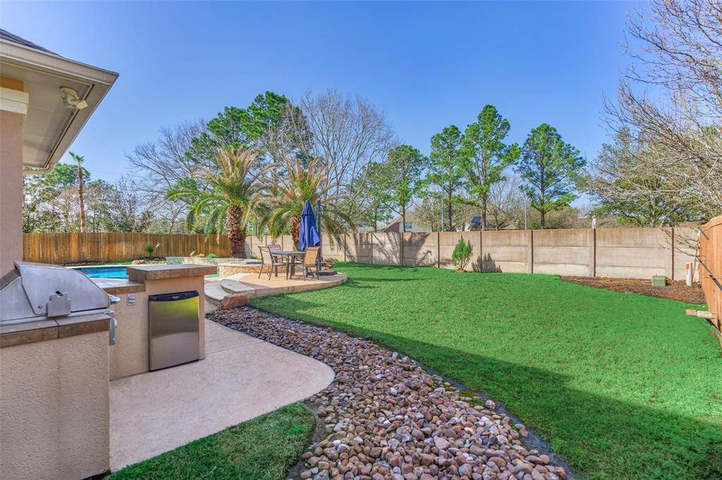Tranquil backyard oasis with lush greenbelt views.