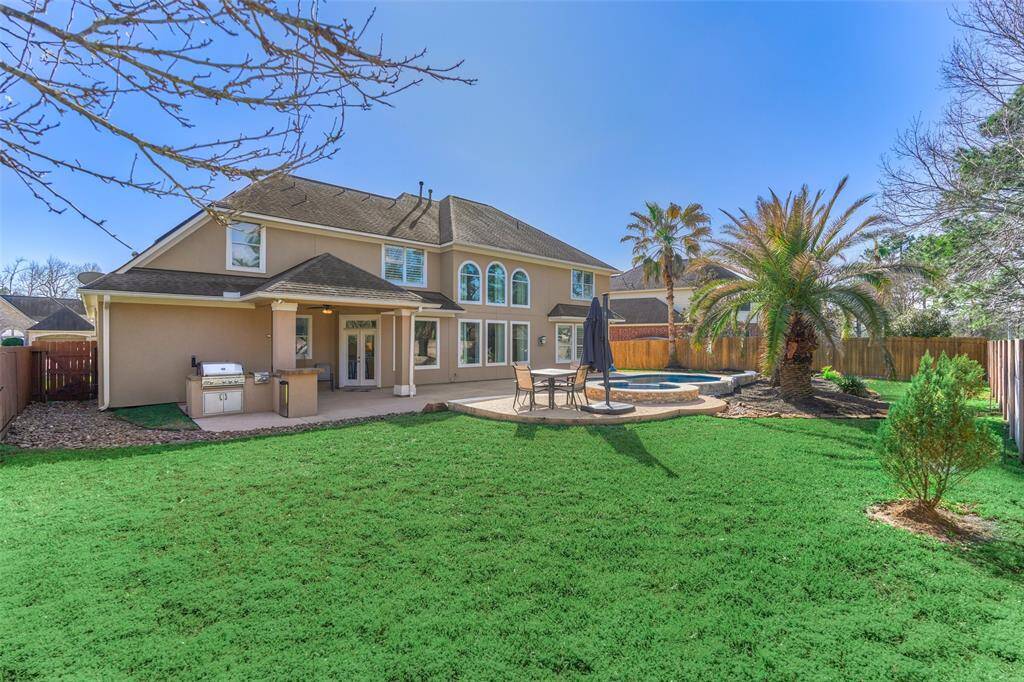 Experience luxury in your own backyard with a sundeck and outdoor kitchen, perfect for grilling and entertaining.