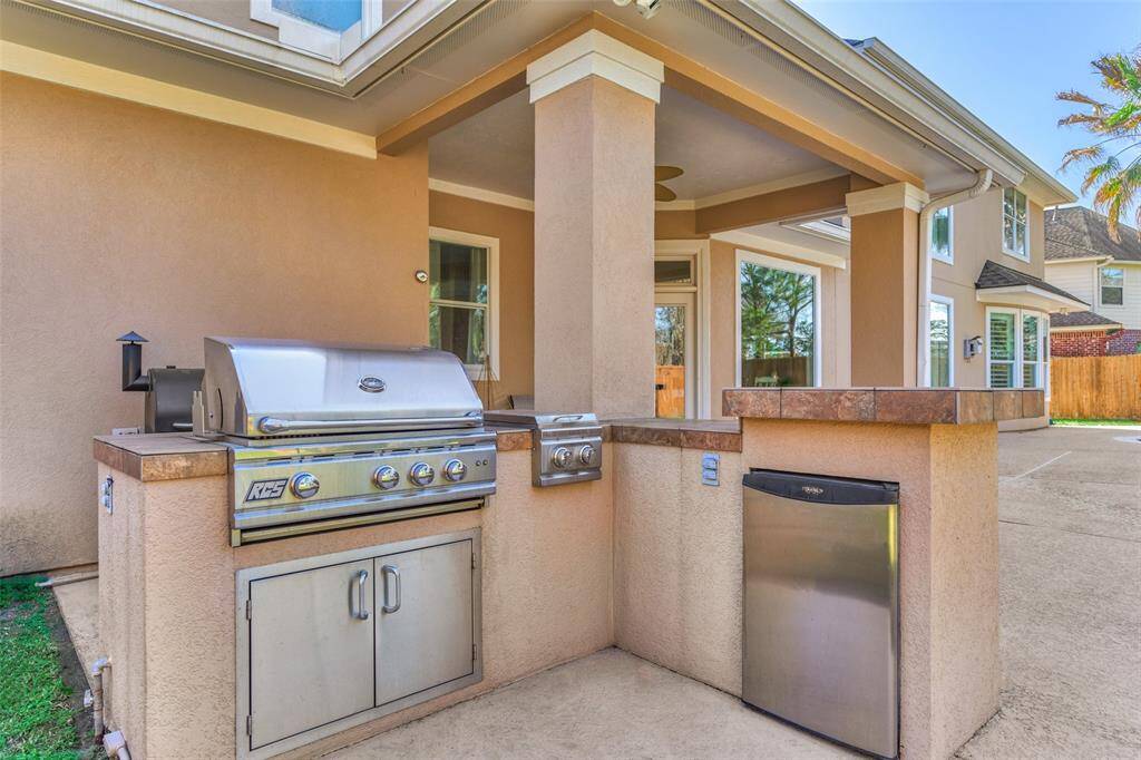 Outdoor grilling oasis with a built-in fridge for ultimate convenience.
