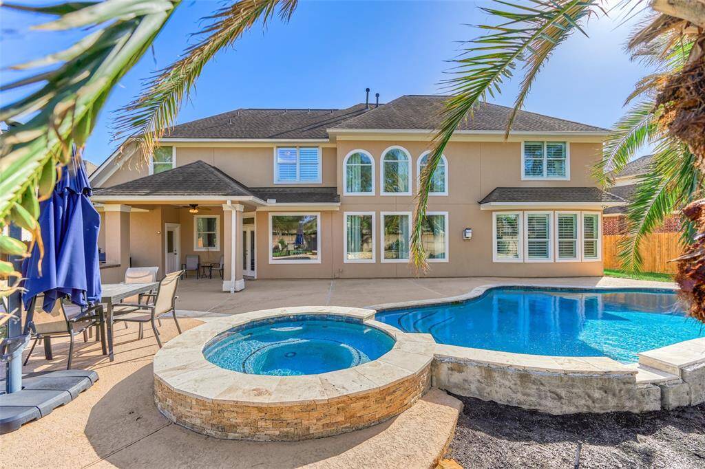 Elegant stacked stone enhances the allure of the raised spa.
