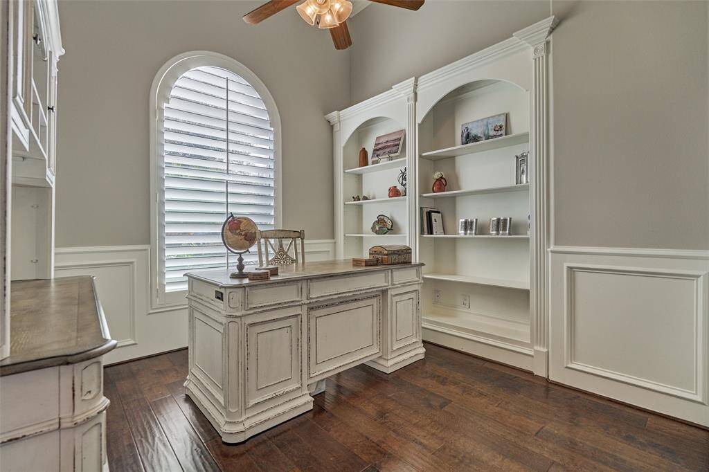 Elegant study with custom built-ins, gleaming hardwood floors, and abundant natural light.