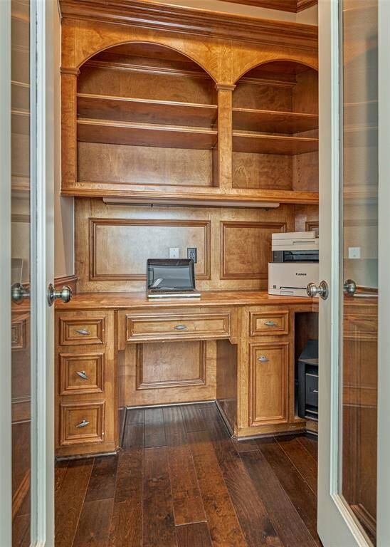 This study features elegant built-in cabinets and a stylish desk, perfect for productivity and organization.