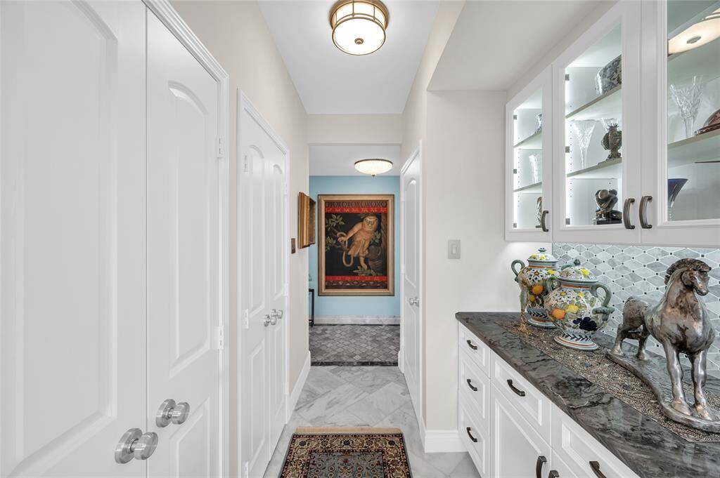 Another view through the kitchen towards the front hall way. Pantry and washer/dryer are located behind the doors on the left.