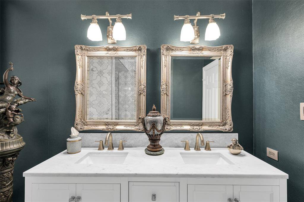 This beautifully designed bathroom features a spacious double vanity with sleek countertops and ample storage. Modern faucets and high-end  finishes complete the sophisticated look, making this area both functional and luxurious.