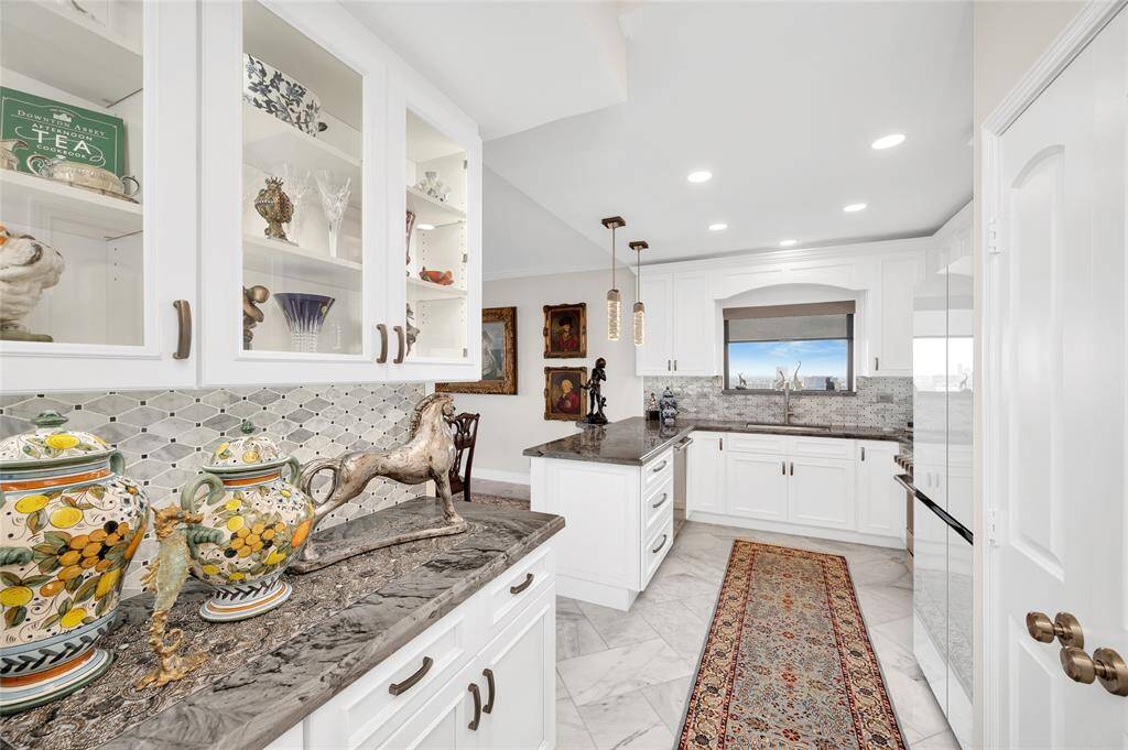 The added bonus of a kitchen window, butler's pantry and peninsula enhances this space from merely utilitarian to aesthetically appealing.