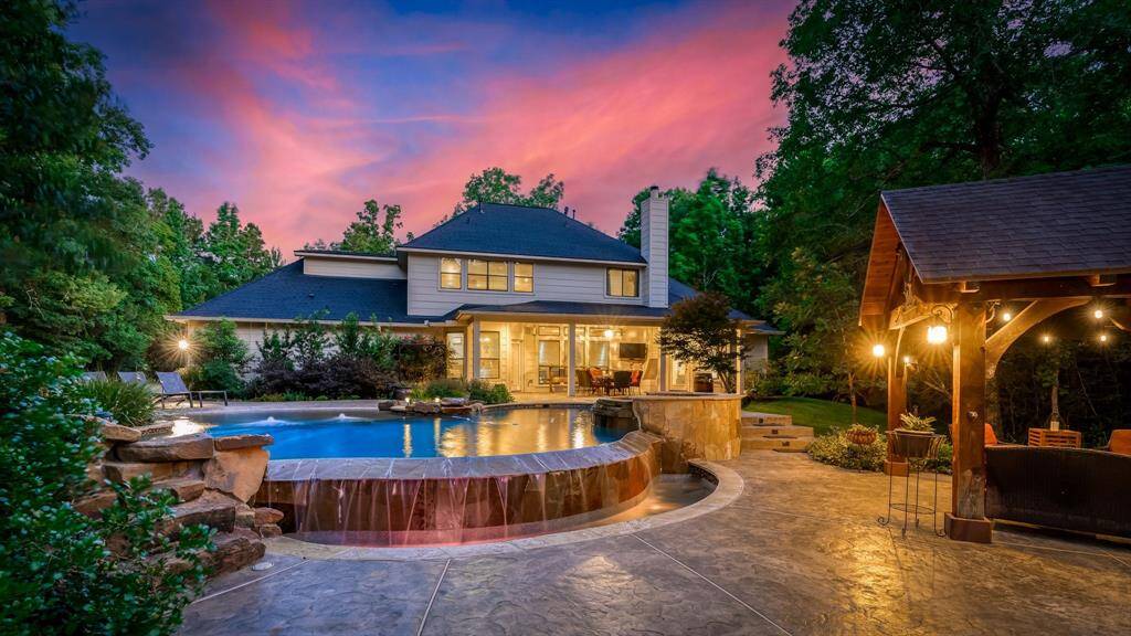 Beautiful pool with infinity edge, oversized beach entry, waterfall, extensive stamped concrete decking and PERGOLA! All of this on nearly 3 wooded acres. This is a cul-de-sac lot.
