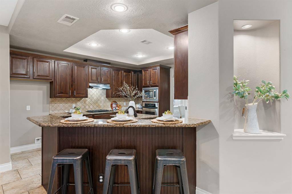 Kitchen eat-in bar with beadboard paneling.