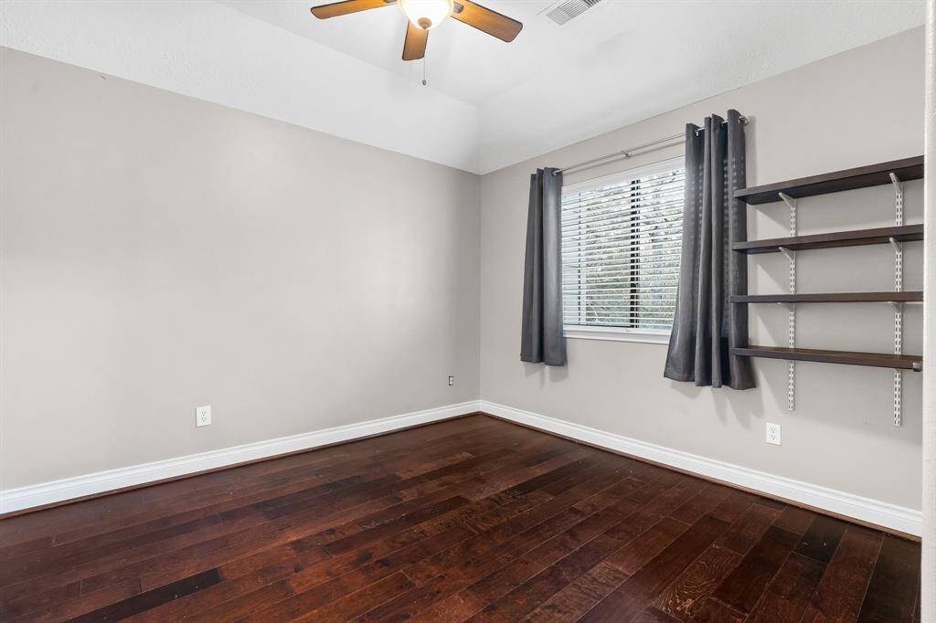 Secondary bedroom has shelving and walk-in closet.