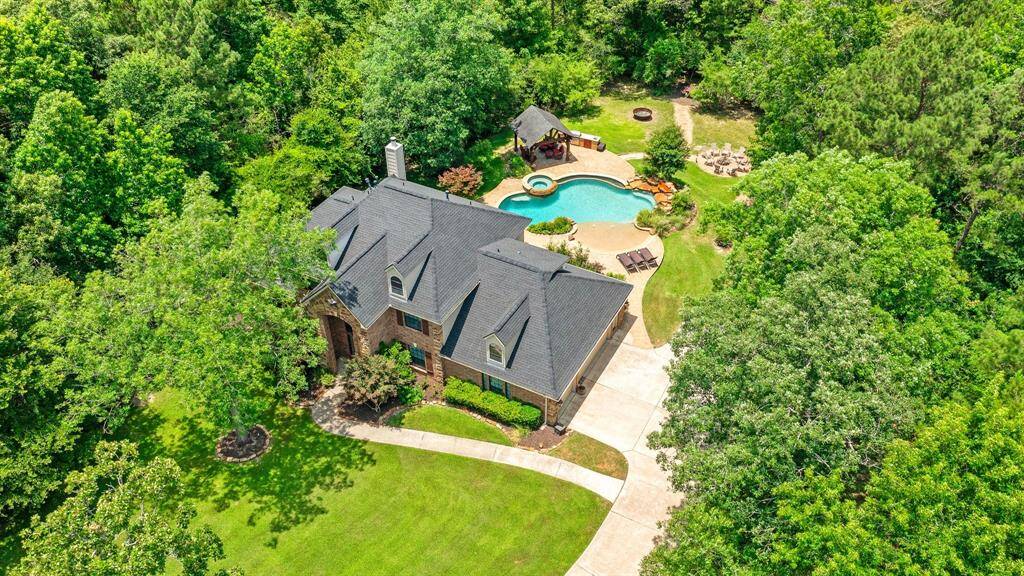 Aerial view of home and property. Notice all of the trees.