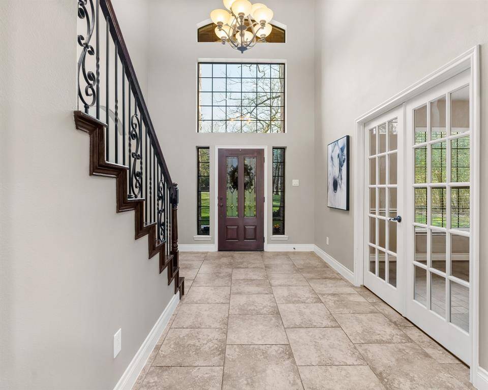 Lovely entryway with tall ceilings and lots of natural light.