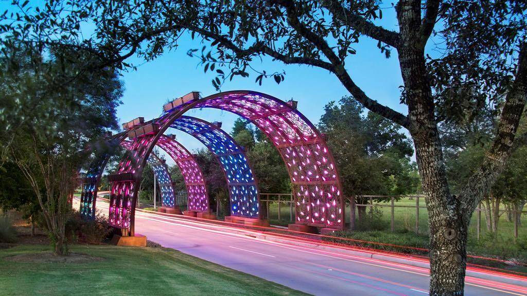 At night, the Living Arches come alive as well with LED lights in color-coordinated colors during different times of the year or even to celebrate victories of hometown teams! Blue and orange for the Houston Astros, sure!!! Come and check them out at night! They are such a fun way to welcome you home!