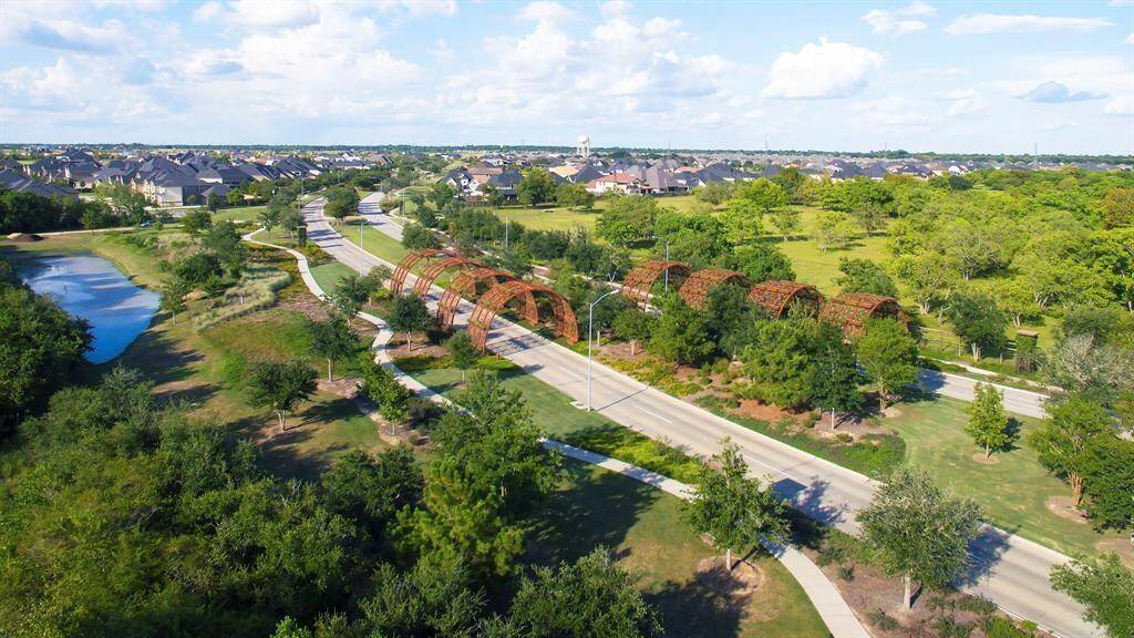 Aerial view of the Living Arches which welcome you and beckon you back into and out of Cane Island. There are trails that runners and cyclers love to use daily in Cane Island! There are also lush landscapes on Cane Island Parkway that make a simple stroll very enjoyable. Come and live the resort-style life in Cane Island!