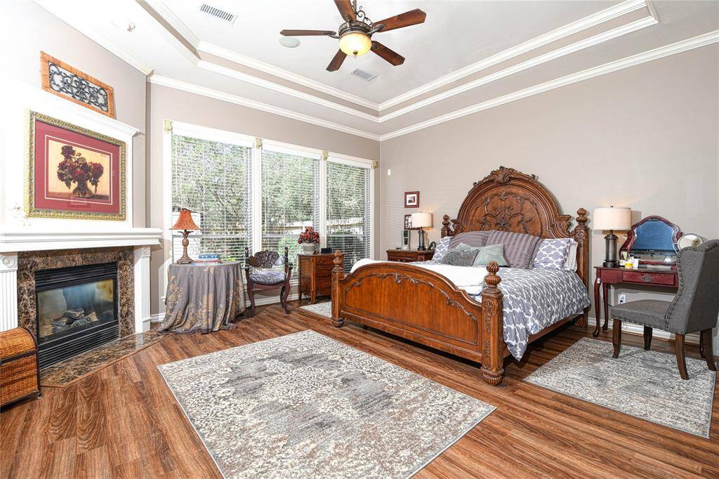 Primary Bedroom with fireplace and views of the back yard