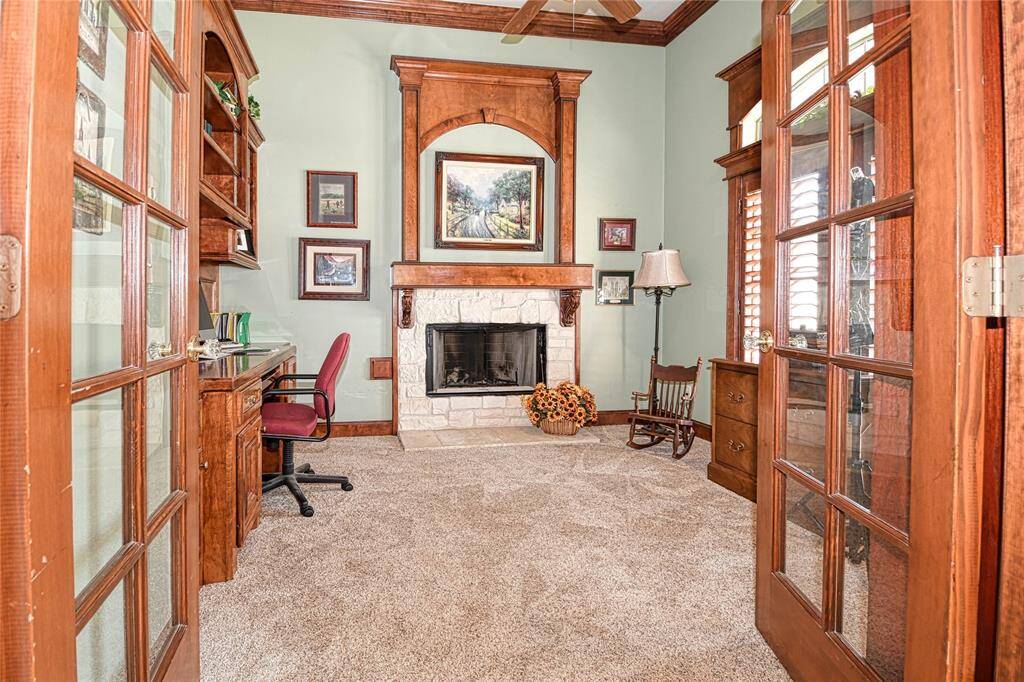 Double door entry to private study with wood burning fireplace