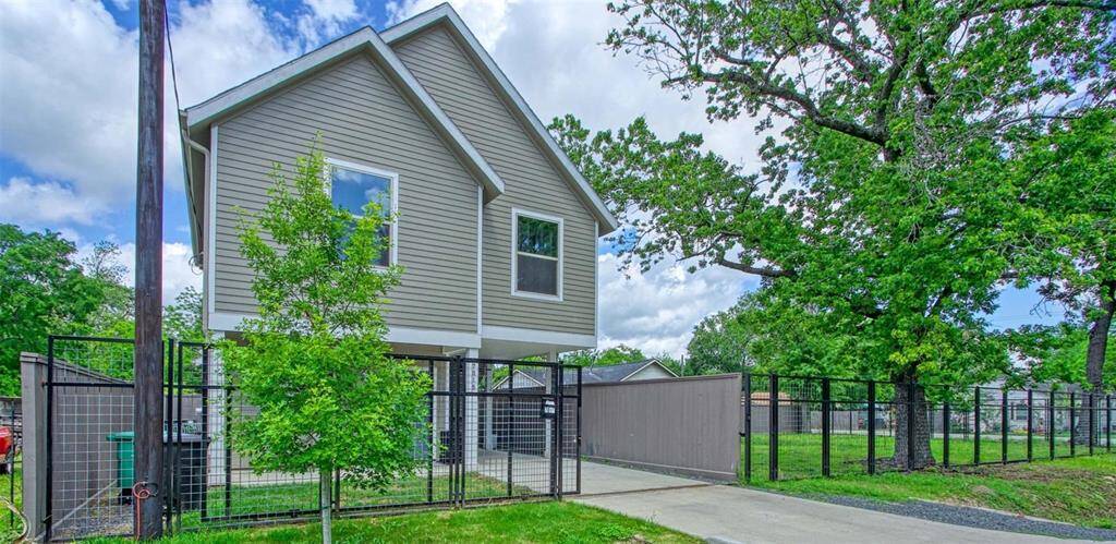This spacious open-concept living area features modern hardwood flooring, ample natural light, and recessed lighting. The kitchen is equipped with stainless steel appliances, a large island with seating, and sleek cabinetry. The living room offers cozy seating and a stylish entertainment area, perfect for relaxation or entertaining.
