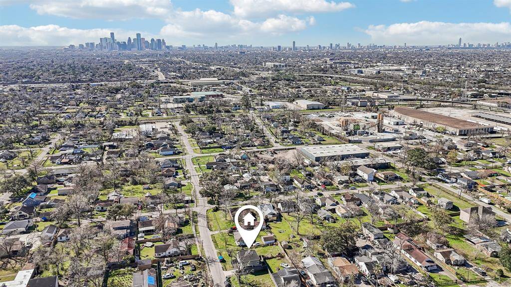 This photo shows a commercial area featuring a Whole Foods Market with ample parking. The location includes various services like a 24-hour emergency center, fitness, and retail options, providing convenient amenities for nearby residents.