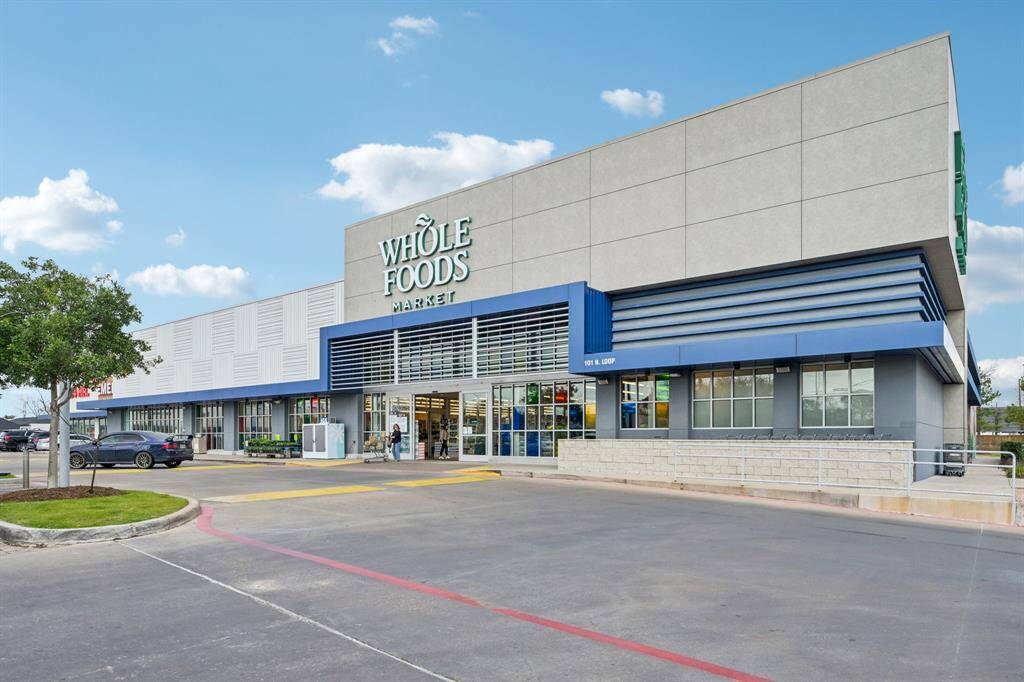 This photo shows a modern, well-maintained Whole Foods Market with ample parking space, ideal for convenient grocery shopping in the area.